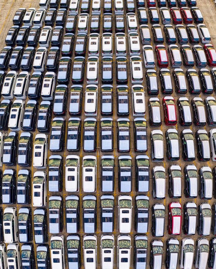 Aerial view of neatly parked cars in rows, showcasing urban transportation organization in Jakarta.